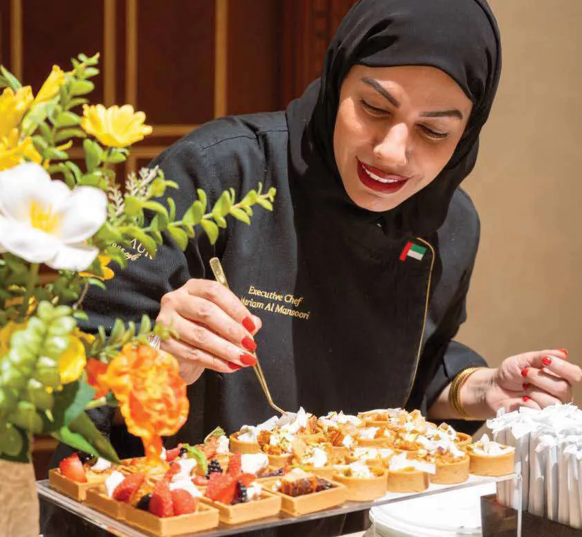 Chef Mariam finishing canape trays for service