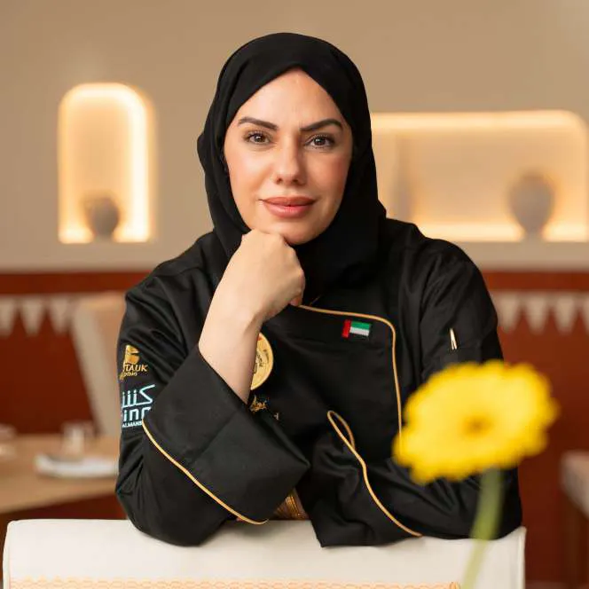 Chef Mariam seated at the Amina counter