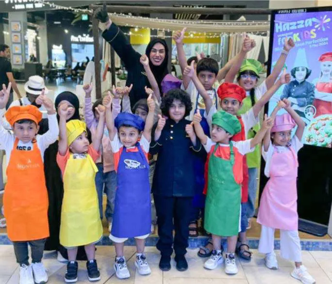 Academy kids with their arms up after a workshop